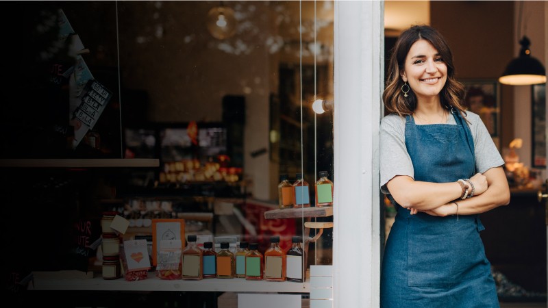 Smiling woman outside her shop