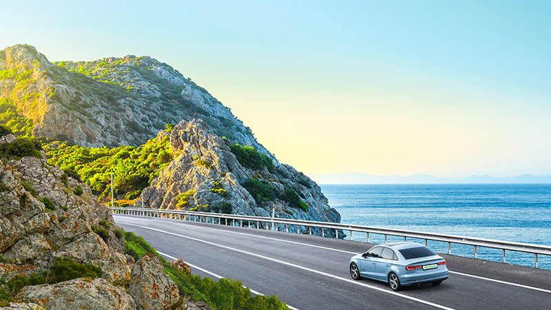 car driving along mountain road